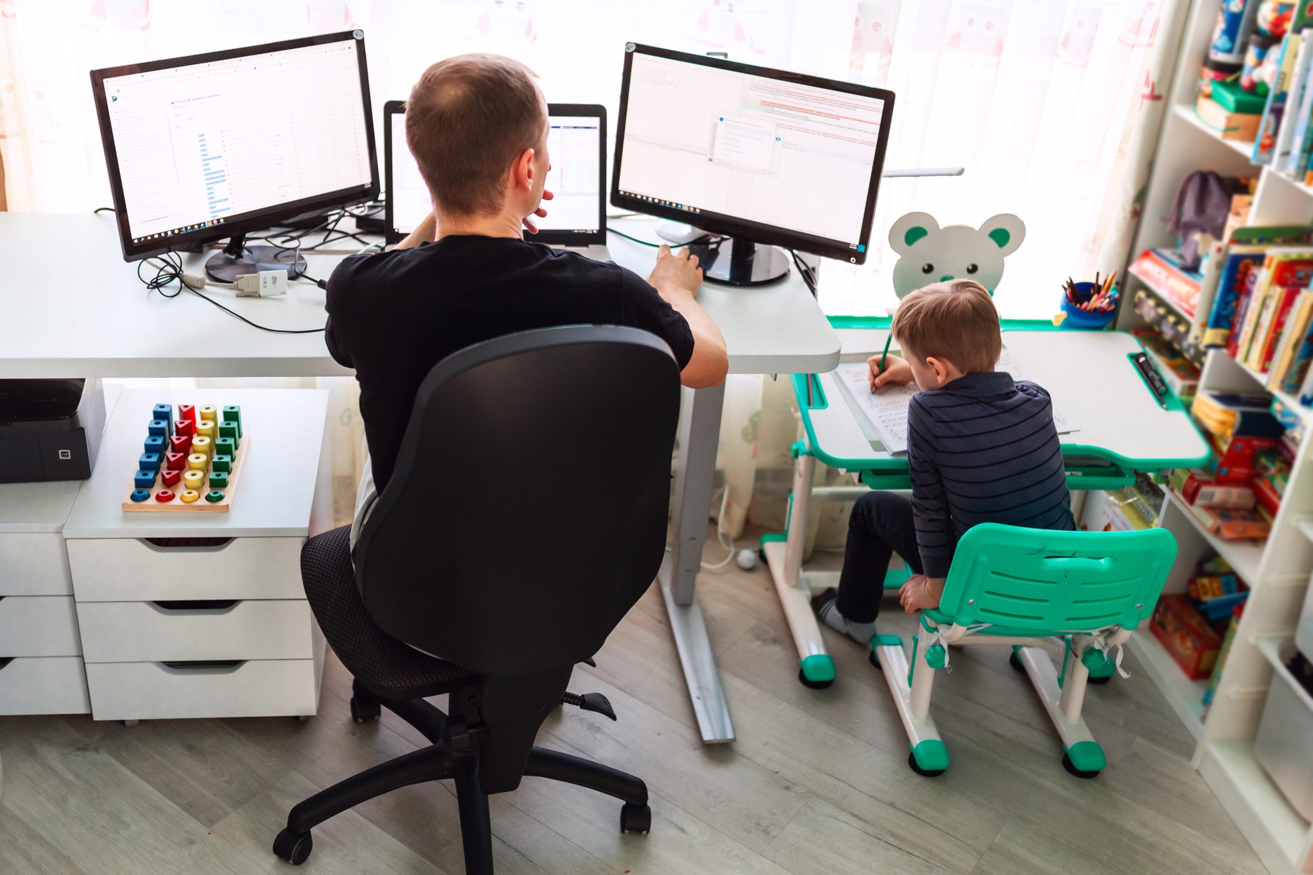 Father with kid working from home during quarantine. Stay at home, work from home concept during coronavirus pandemic father with kid working from home