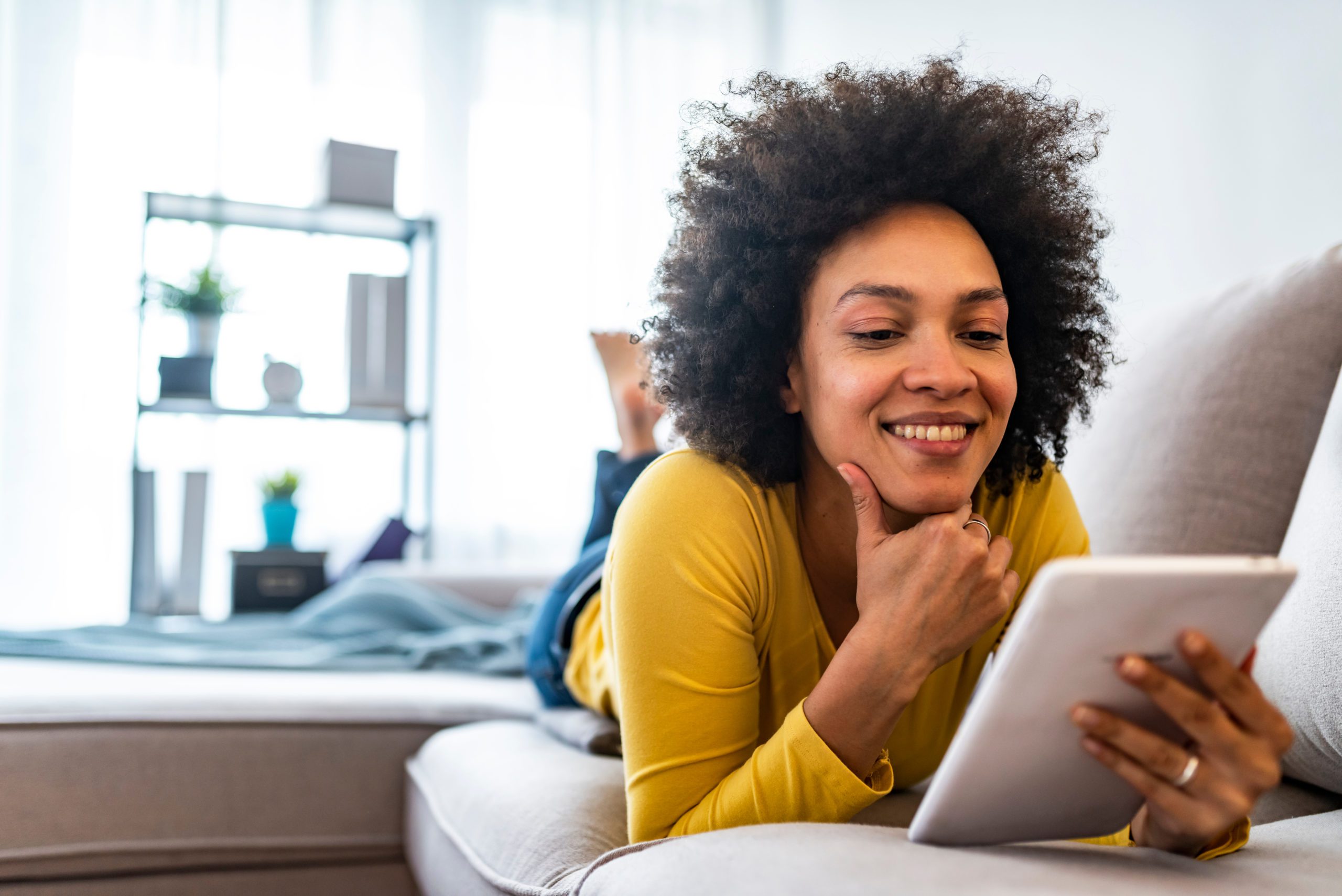 Happy,Young,Woman,With,Tablet,Pc,Laying,On,Sofa.,Young